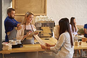 coffee shop cashier taking an order on POS