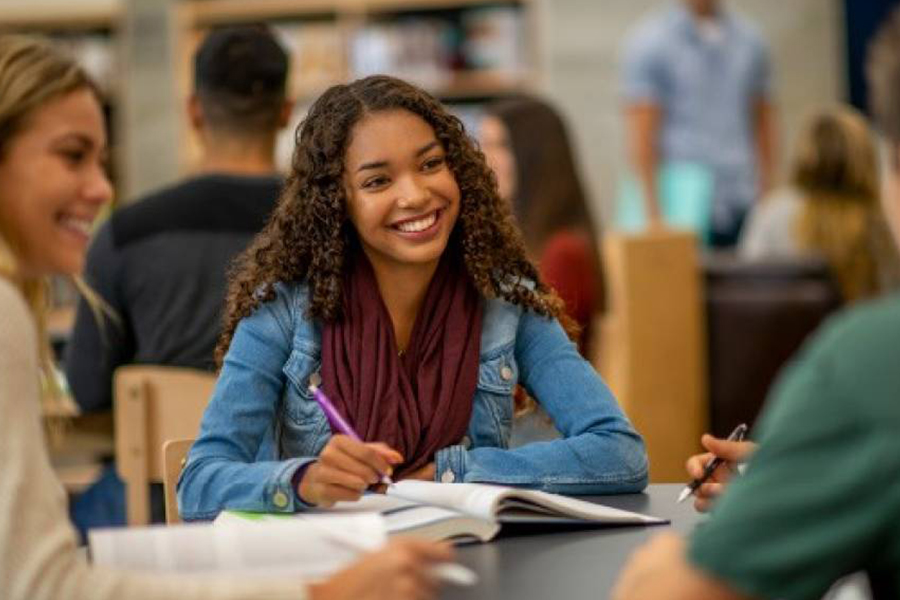 student studying with friends at the library