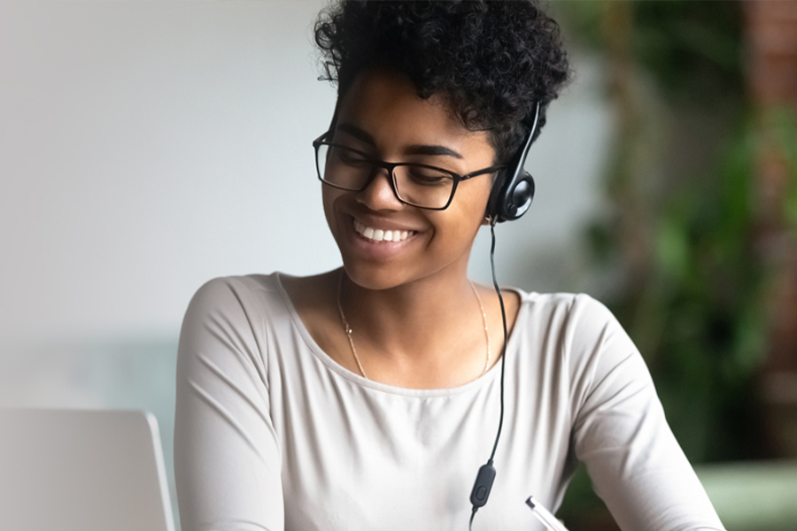 young woman watching a webinar on her computer