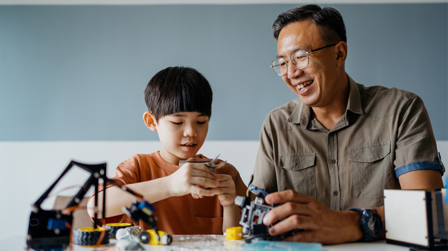 a father and son working on a project together