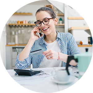 woman on the phone holding a credit card