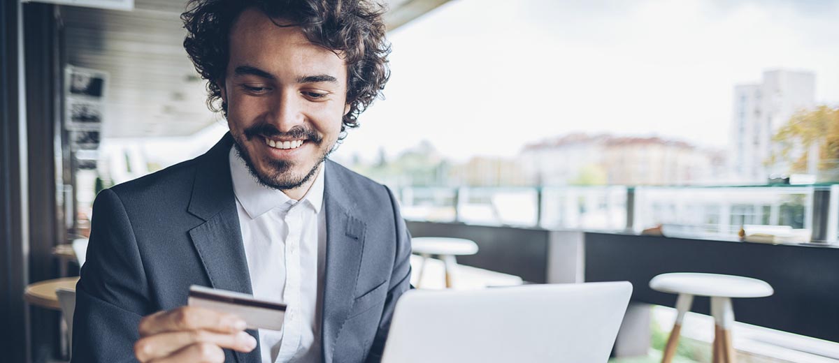 Photo of man looking at credit card.