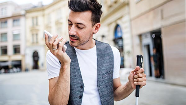 Blind man speaking into his mobile phone