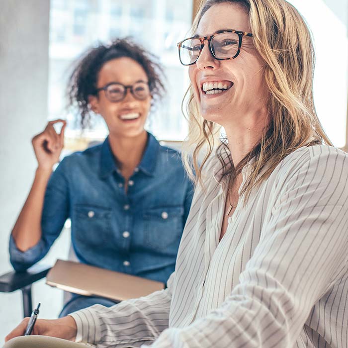 Women seating and smiling together