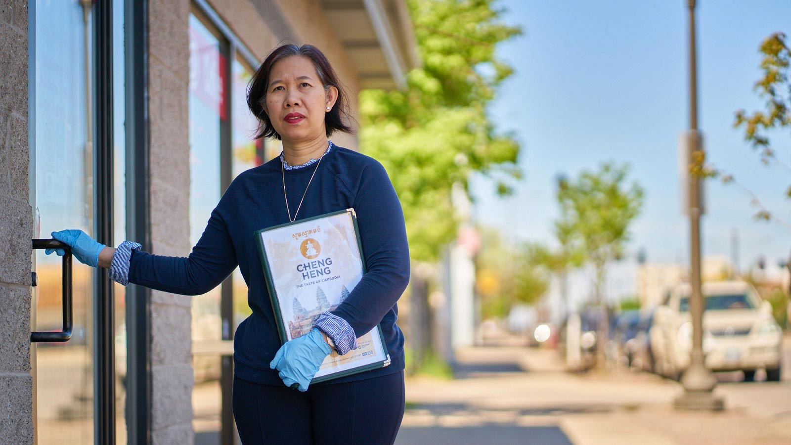 Business owner stands outside her restaurant