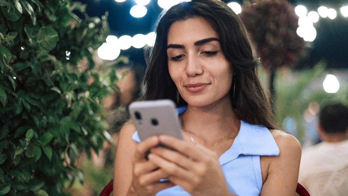 A woman looks at her phone