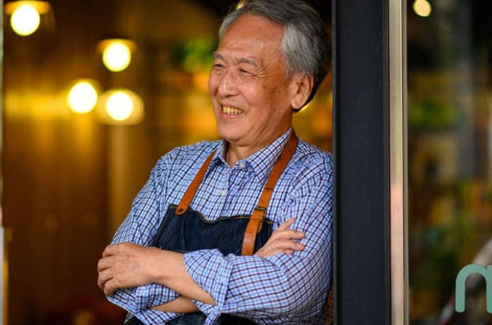 Male restaurant owner standng in doorway