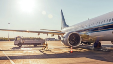 Airplane being fueled by cargo truck