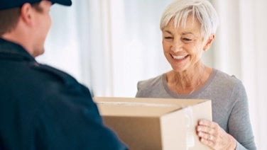 A person handing a package to another person