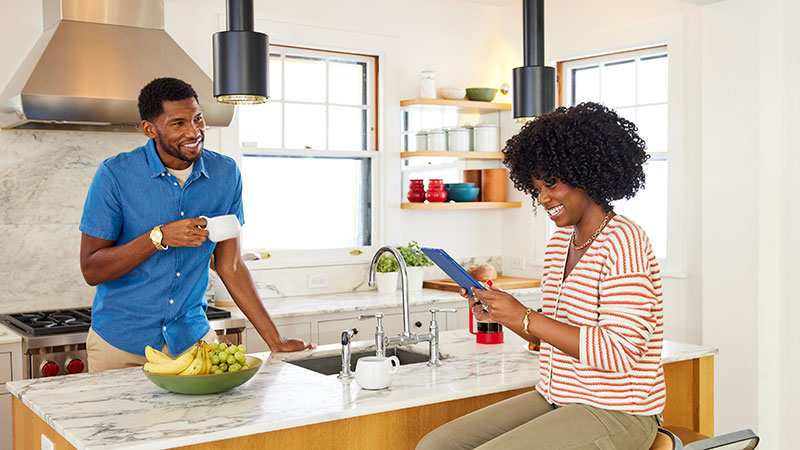 Couple sitting in their home kitchen.