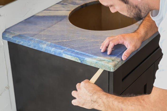 Man installing a new bathroom vanity countertop