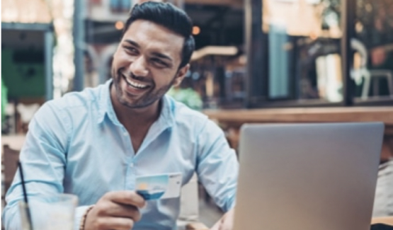 man at computer with credit card