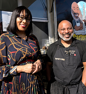 Man and woman standing in front of food truck