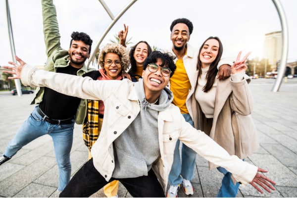 A group of college students posing for a happy picture together.