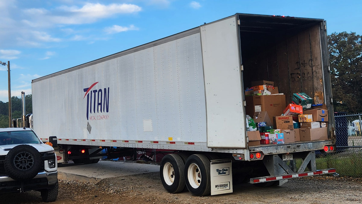 18-wheeler truck with back open, showing donated supplies.