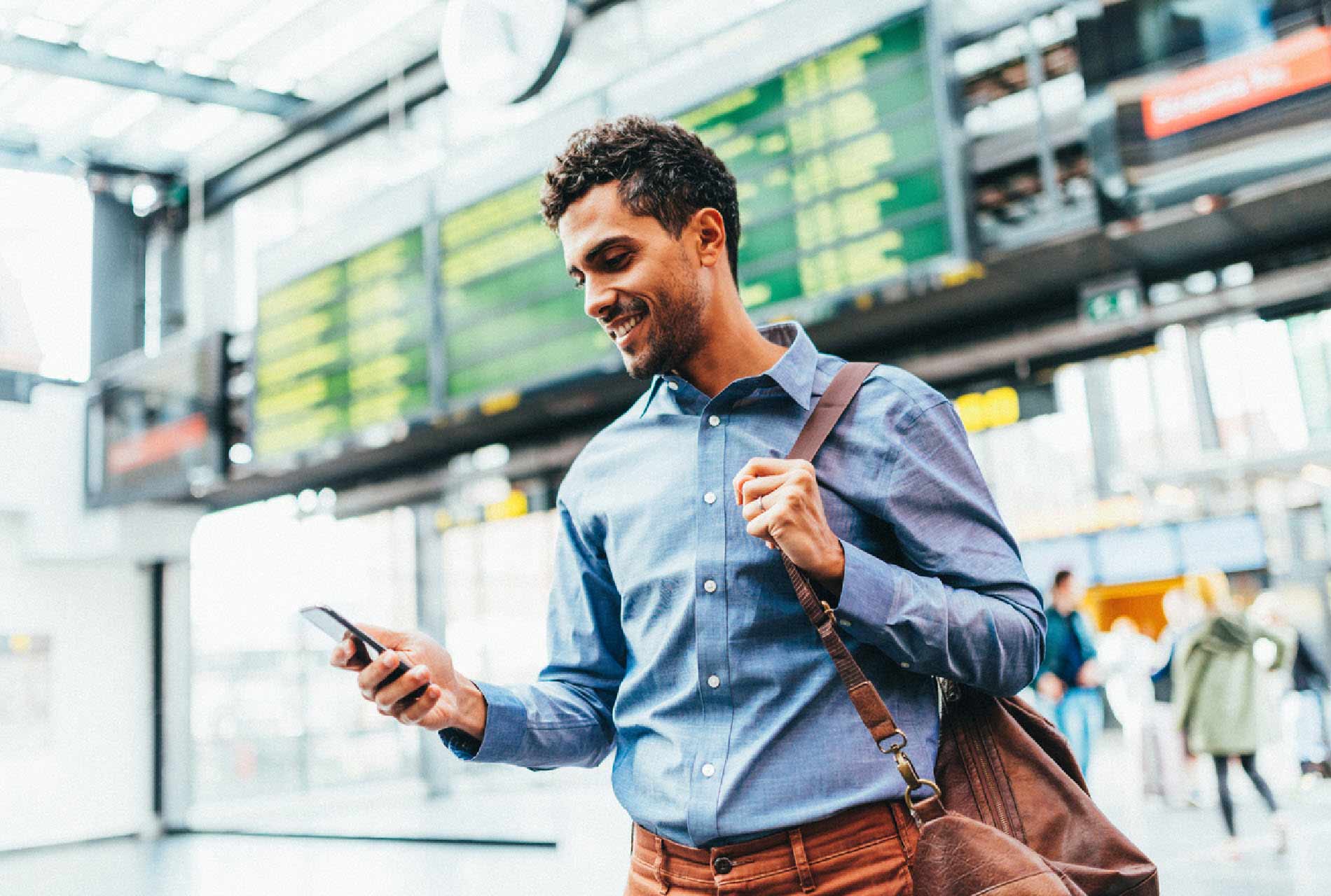 Man at airport looking at phone