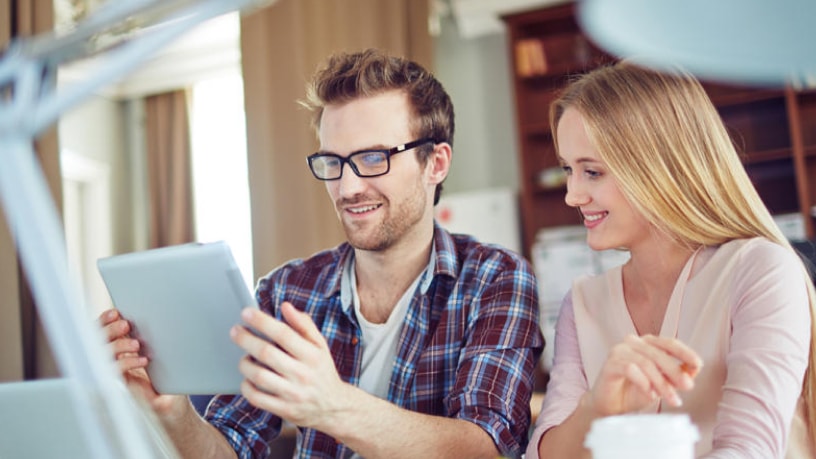 Couple viewing steps online to transfer banks