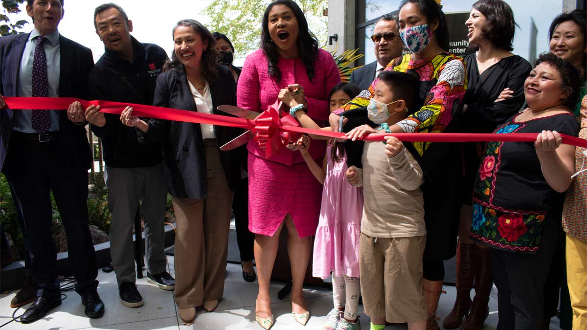 Group celebrating ribbon cutting at public event