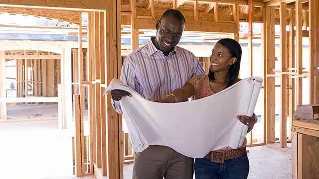 A couple examines their future home, learning about low-income home buying options