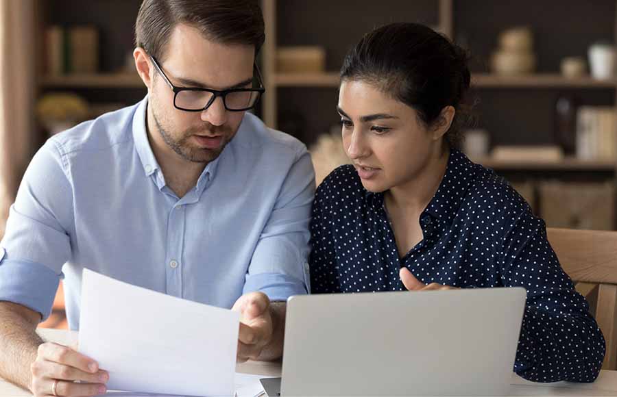 A couple reviewing documents that compares adjustable-rate and fixed-rate mortgage options