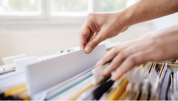 hands in a filing drawer