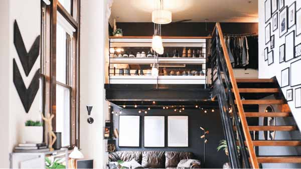 A cozy living room featuring a staircase and a comfortable couch, inviting relaxation and warmth