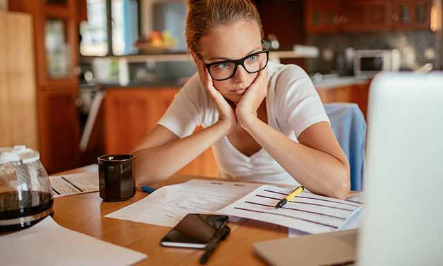 A woman on her laptop exploring first-time home buyer loan options