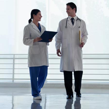 Two doctors walking down a hallway.