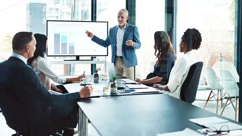 Man and woman in a conference room discussing ETF trends