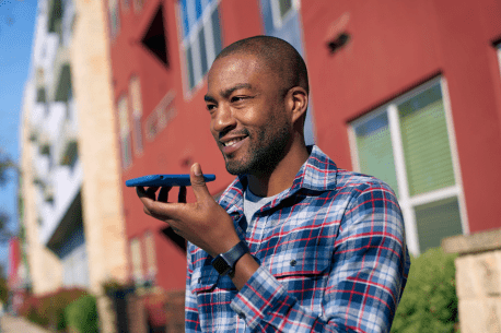 Person interacting with Smart Assistant on a phone using voice