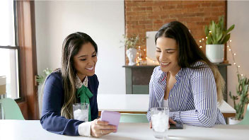 Two friends discussing high yield savings accounts