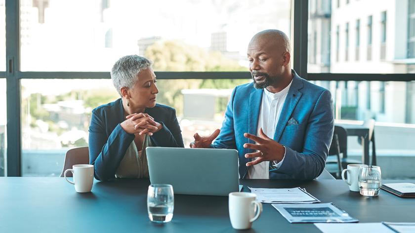 Man and woman discussing Roth IRAs