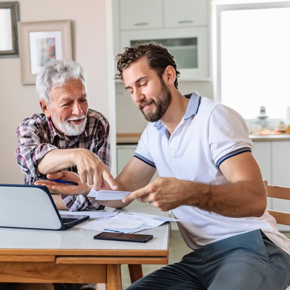 Father and son reviewing paperwork