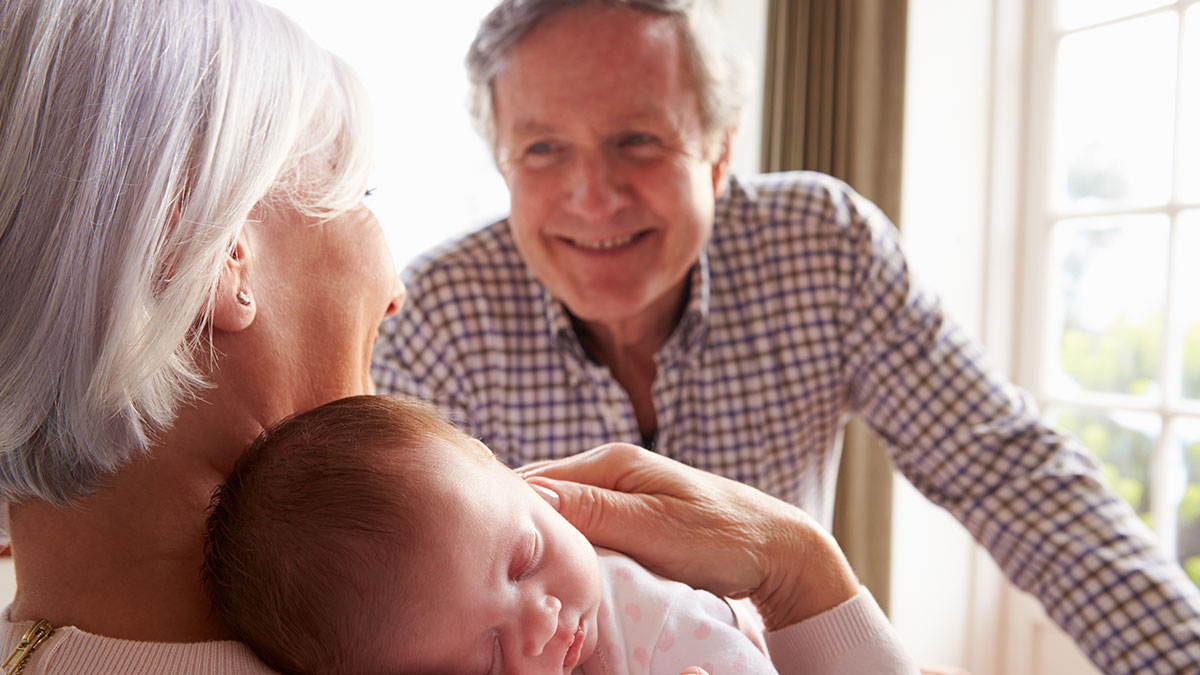 grandparents holding newborn