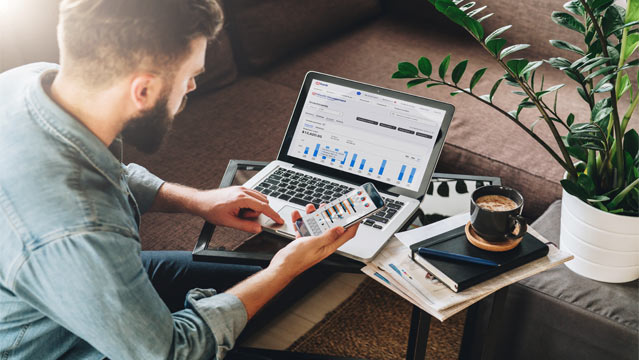 Man reviewing investments on laptop