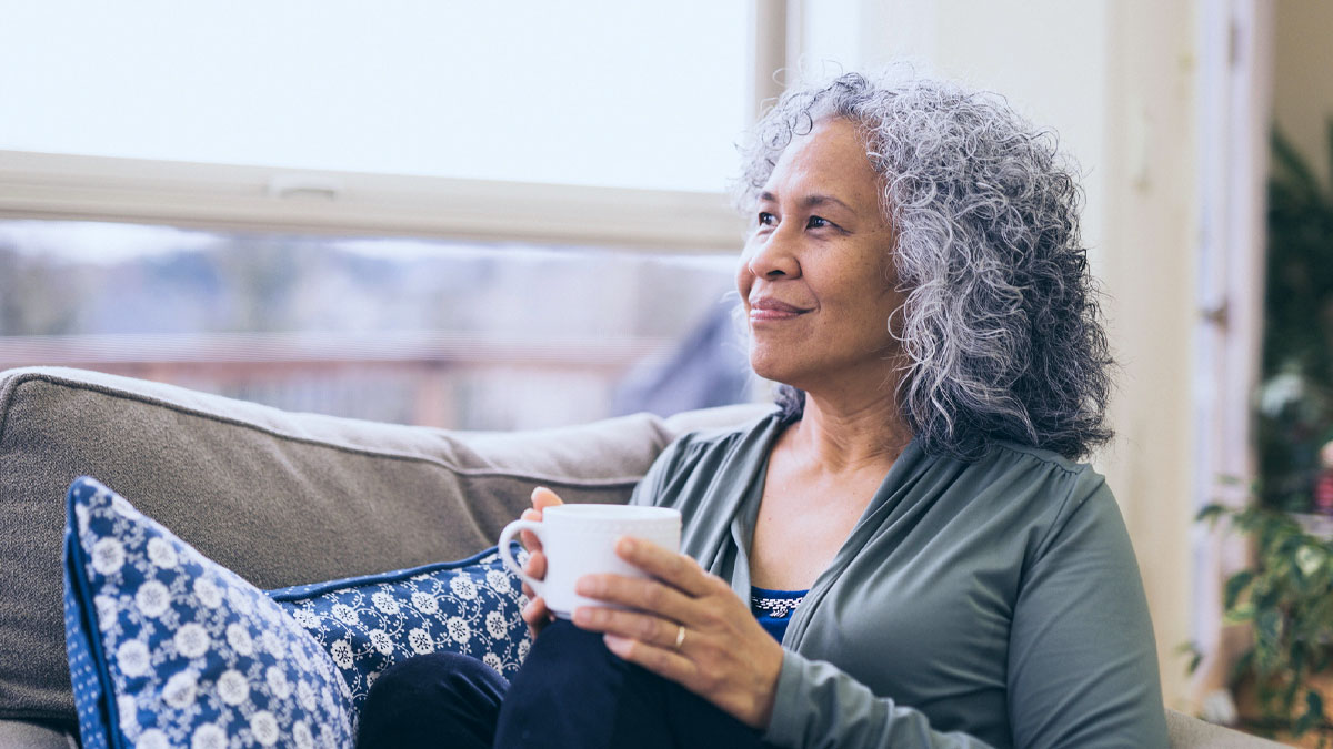 mature woman outside drinking coffee