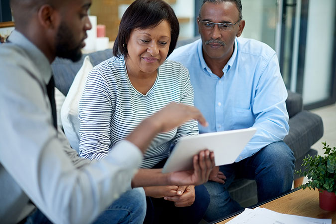 Three people looking at tablet