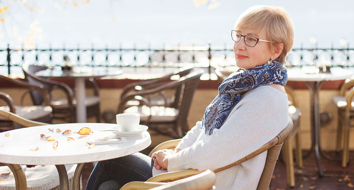 woman at table with coffee