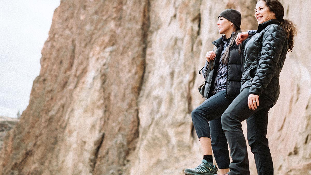 Two women looking out from cliff