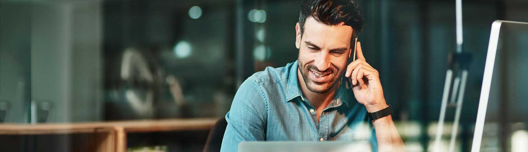 people in an office looking at a laptop