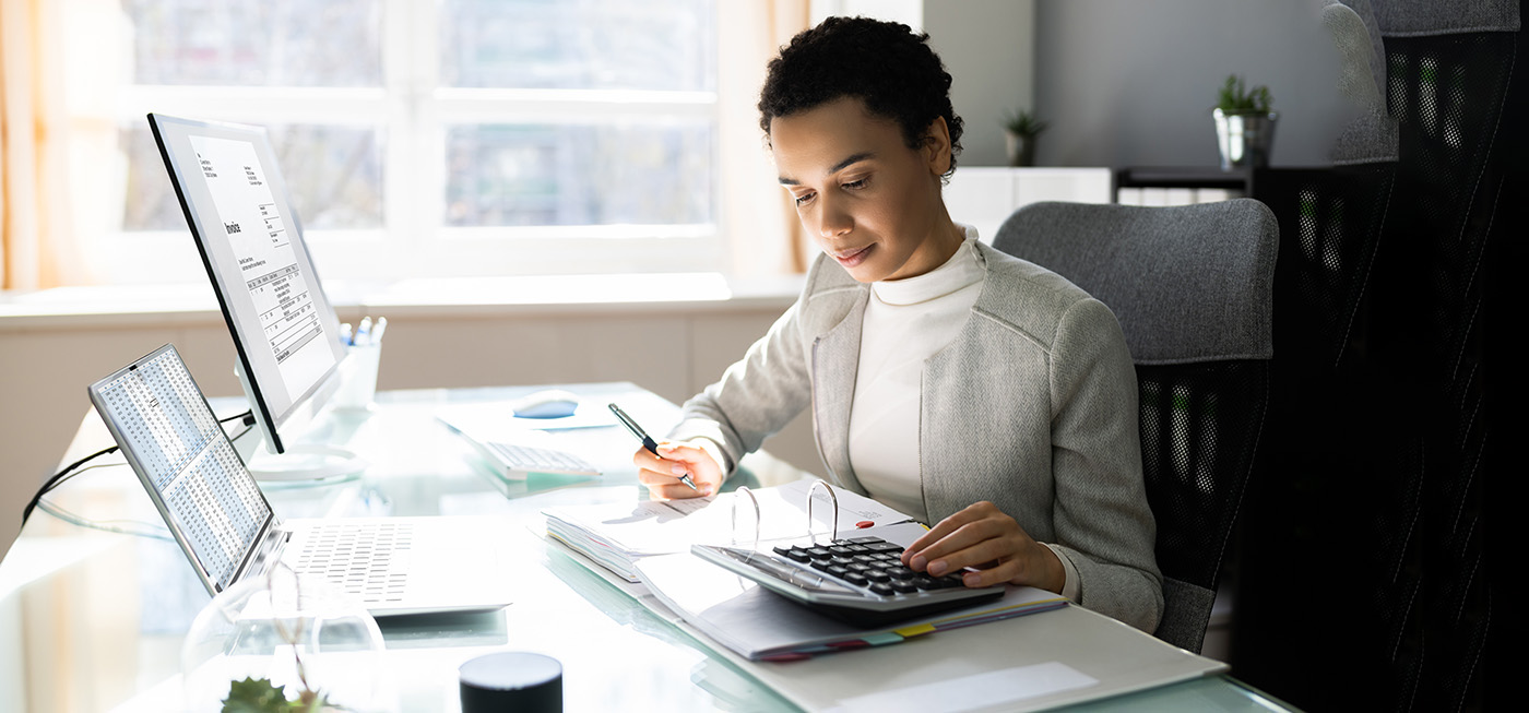 Young Black woman doing work at her office desk