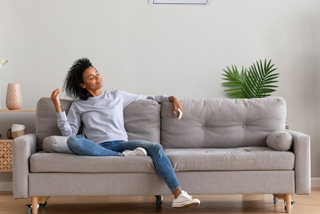 woman sitting on her couch