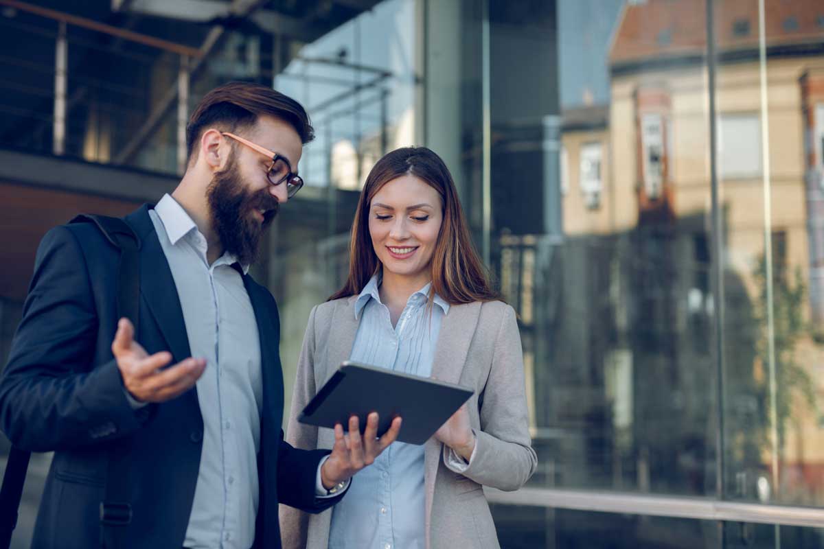 Two coworkers discussing topic outside of an office