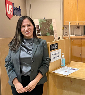 Woman standing next to service window.