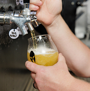 A Protector beer being poured into a glass