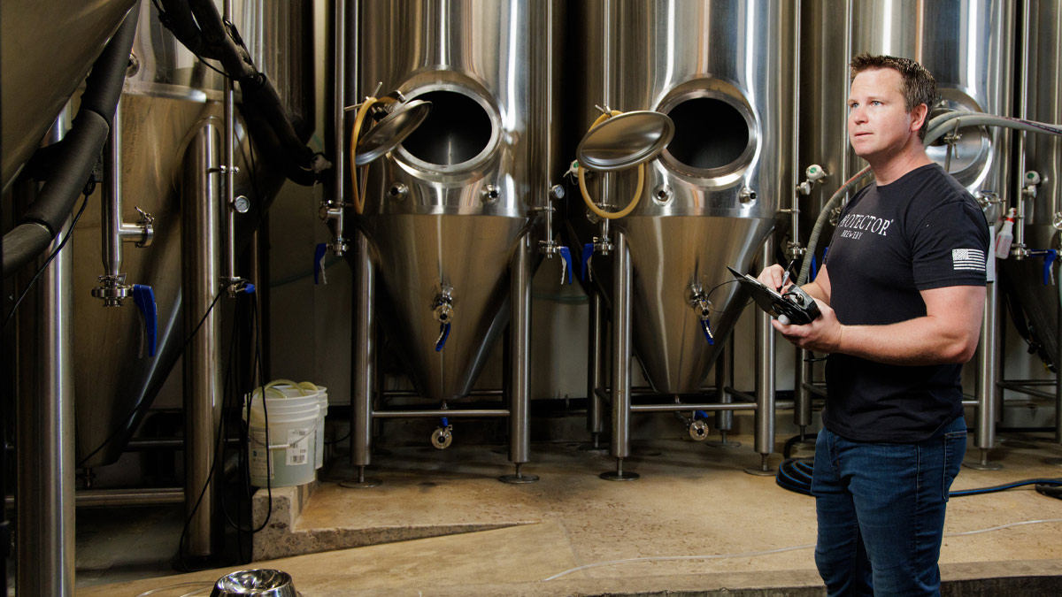 Brewery owner Sean Haggerty standing in front of the tasting room bar