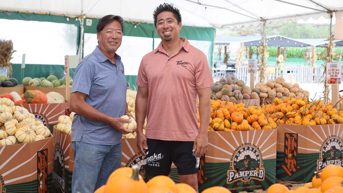 Two men at a produce stand.