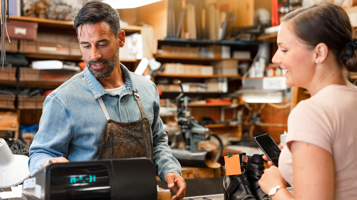 Man business owner serving woman customer.