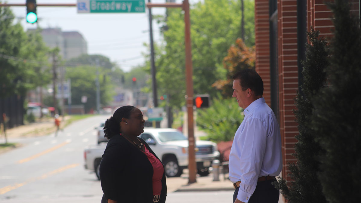 Cassandra and Mike having a conversation in front of Mosaic Templars Cultural Center building