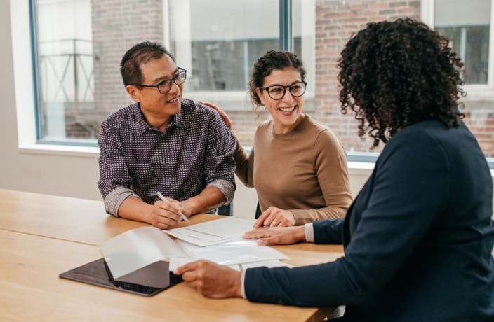 Banker meeting with two business owners